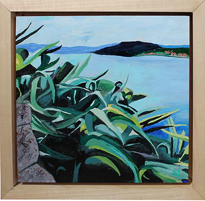 From over the Napflio harbor in Greece looking through broad leafed plants.
