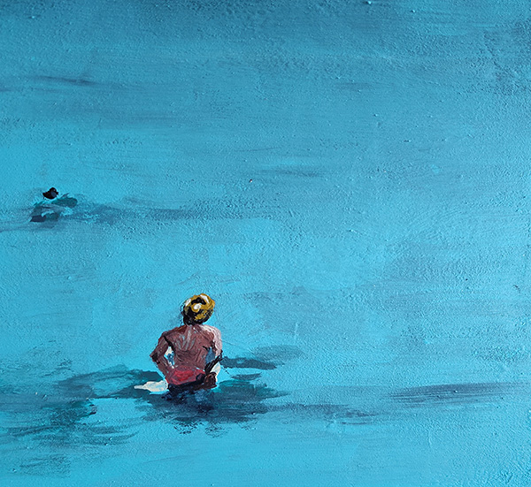 woman seen from the back wading into the ocean with another person off in the distance