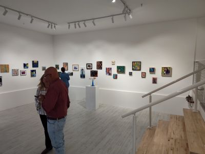 View of gallery with paintings on the wall